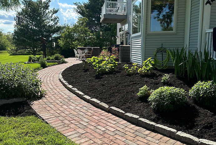 A brick walkway in front of a house