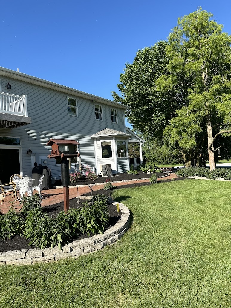 A house with a large lawn and a patio