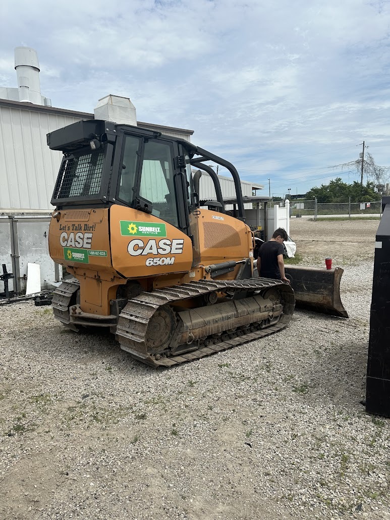 A man is working on a construction vehicle